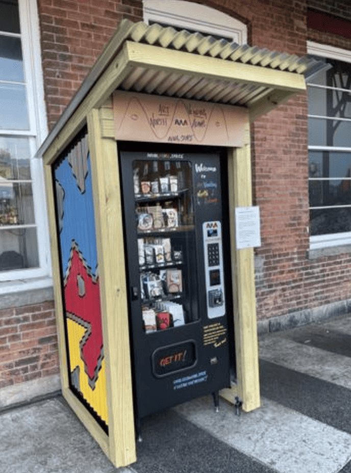 a vending machine sitting on the side of a street.